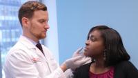 Doctor checking patient's face
